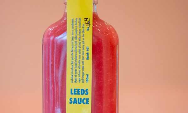 A close up of a pink bottle of Leeds Sauce