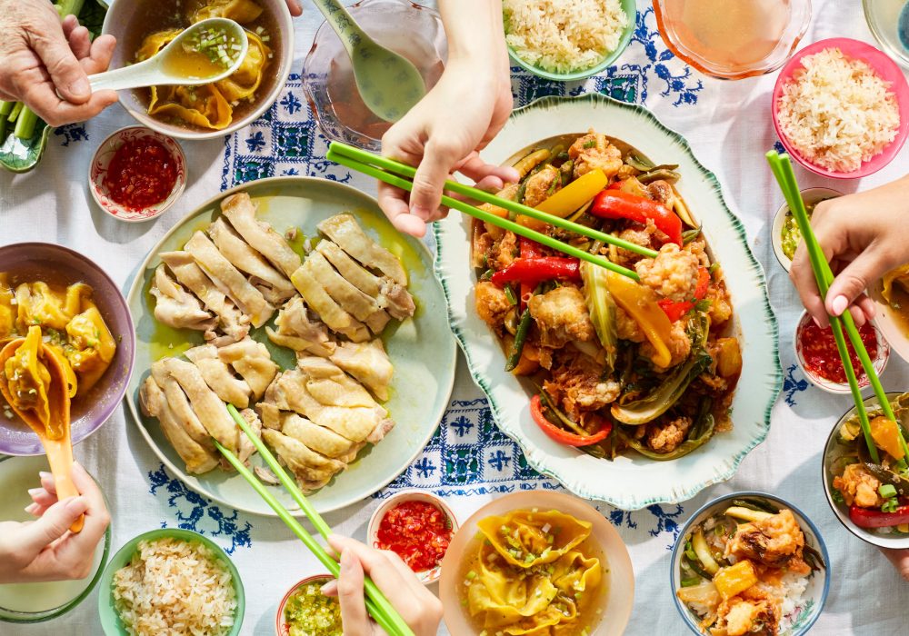 A delicious spread of Chinese dishes including dumplings, poached chicken and more