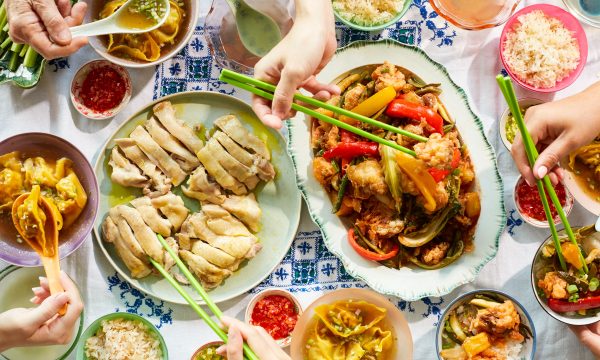 A delicious spread of Chinese dishes including dumplings, poached chicken and more