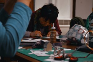 Images of people participating in From Ashes paper-modelling workshops